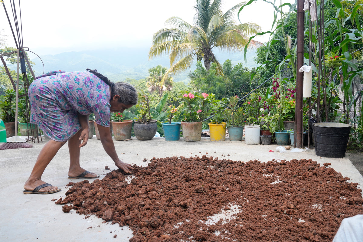 Woman checking texture of dried clay