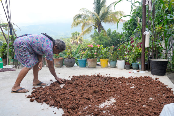 Woman checking texture of dried clay