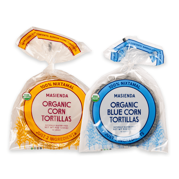 Two packages of Masienda organic corn tortillas, one orange and one blue.